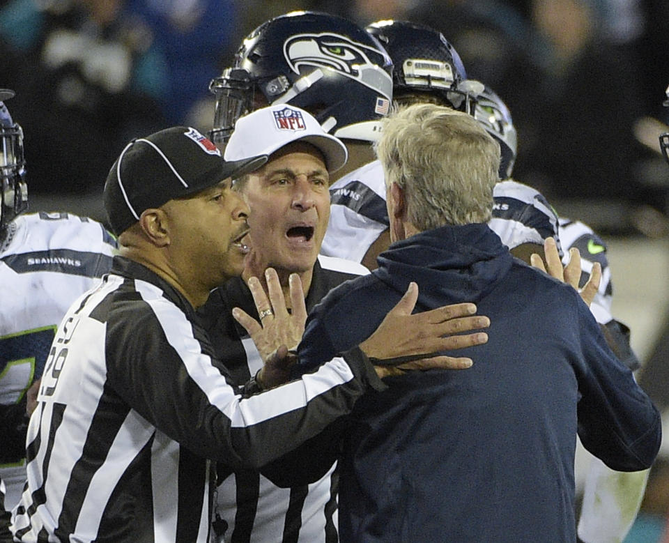 Seattle Seahawks head coach Pete Carroll is held back by officials at the end of last week's game against the Jaguars. (AP)