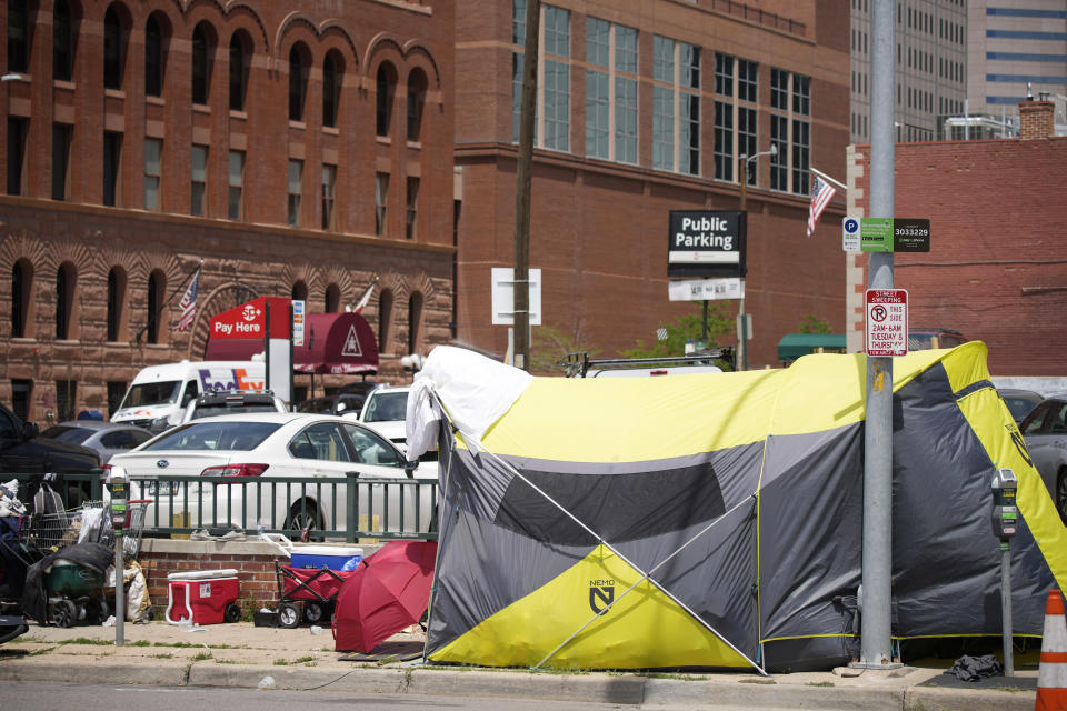 A tent put up by homeless individuals sits on a sidewalk Thursday, July 8, 2021, one block east of the Colorado Convention Center, the site of a major League Baseball promotion to mark the playing of the All Star Game in Denver. (AP Photo/David Zalubowski)