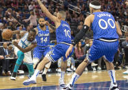 Charlotte Hornets guard Kemba Walker (15) dribbles against Orlando Magic guard D.J. Augustin (14), guard Evan Fournier (10) and forward Aaron Gordon (00) during the first half of an NBA basketball game in Orlando, Fla., Thursday, Feb. 14, 2019. (AP Photo/Willie J. Allen Jr.)