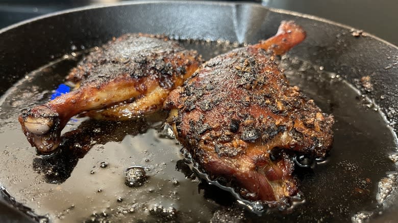 browned duck thighs in pan