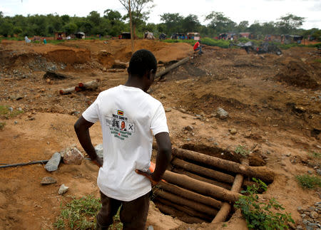 An artisanal miner looks at a pit as retrieval efforts proceed for trapped illegal gold miners in Kadoma, Zimbabwe, February 15, 2019, REUTERS/Philimon Bulawayo