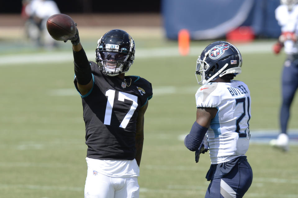 Jacksonville Jaguars wide receiver D.J. Chark (17) signals a first down after a reception against Tennessee Titans cornerback Malcolm Butler (21) in the first half of an NFL football game Sunday, Sept. 20, 2020, in Nashville, Tenn. (AP Photo/Mark Zaleski)