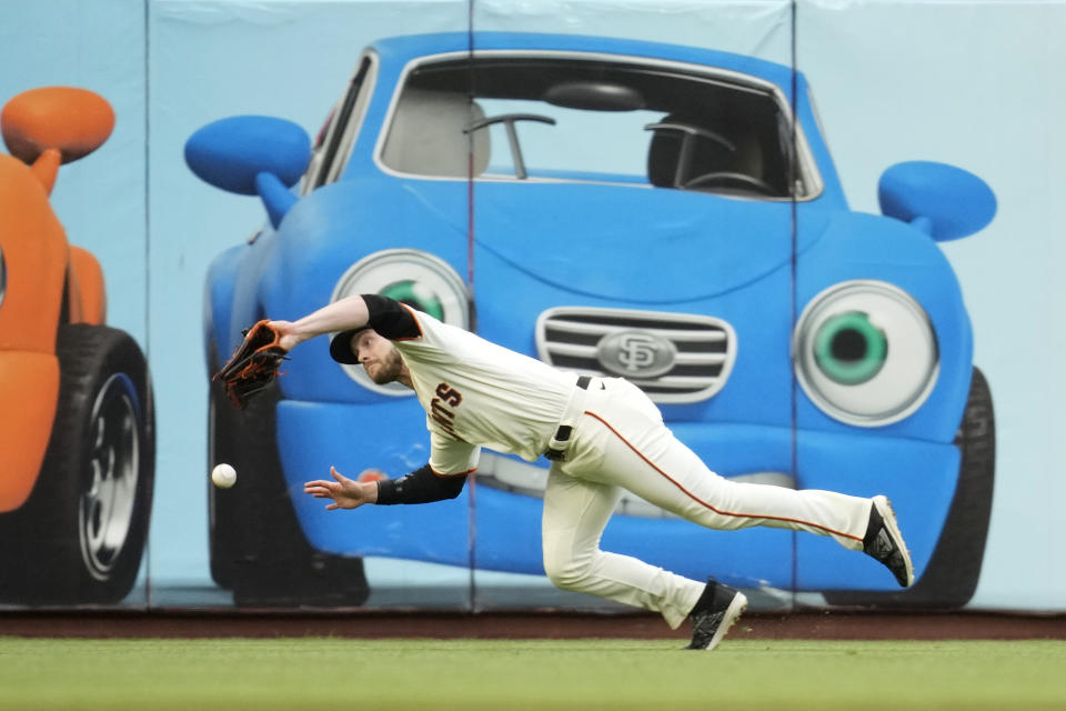 San Francisco Giants left fielder Austin Slater is unable to reach a fly ball hit by the Seattle Mariners' Cal Raleigh in the fifth inning of a baseball game in San Francisco, Wednesday, July 5, 2023. Raleigh doubled on the play. (AP Photo/Eric Risberg)