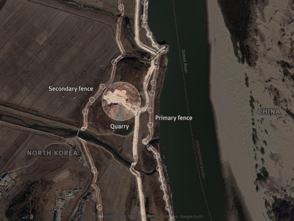 In May 2019, no security is visible along the Tumen River. November 2022 – Primary and secondary fences have been built. A new primary fence and patrol roads are under construction in 2022, using materials sourced from nearby quarry that used to be agricultural fields. The first primary fence (in blue) will be dismantled once the new one is built, as shown in next close up (HRW)