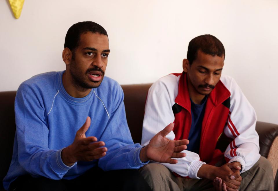 Alexanda Amon Kotey, left, and El Shafee Elsheikh, who were allegedly among four British jihadis who made up an Islamic State cell dubbed "The Beatles," speak during an interview with The Associated Press at a security center in Kobani, Syria.