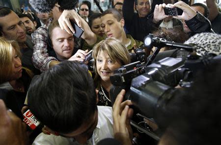 Shula Zaken, who was a long-time aide to former Israeli Prime Minister Ehud Olmert, speaks to the media upon her arrival at Tel Aviv District Court March 31, 2014. REUTERS/Finbarr O'Reilly