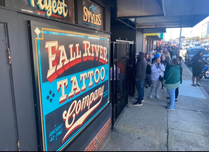 Over 80 people stand in line on South Main Street in Fall River to get a tattoo on Friday the 13th at Fall River Tattoo Co.