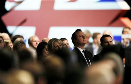 Britain's Prime Minister David Cameron listens to a tribute to former conservative prime minister Margaret Thatcher on the opening day of The Conservative Party annual conference in Manchester, northern England September 29, 2013. REUTERS/Phil Noble