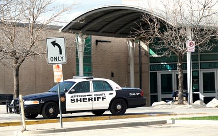 FILE PHOTO: Police vehicles sit outside Columbine High School as some Denver area schools have closed while police search for an armed woman in Littleton, Colorado