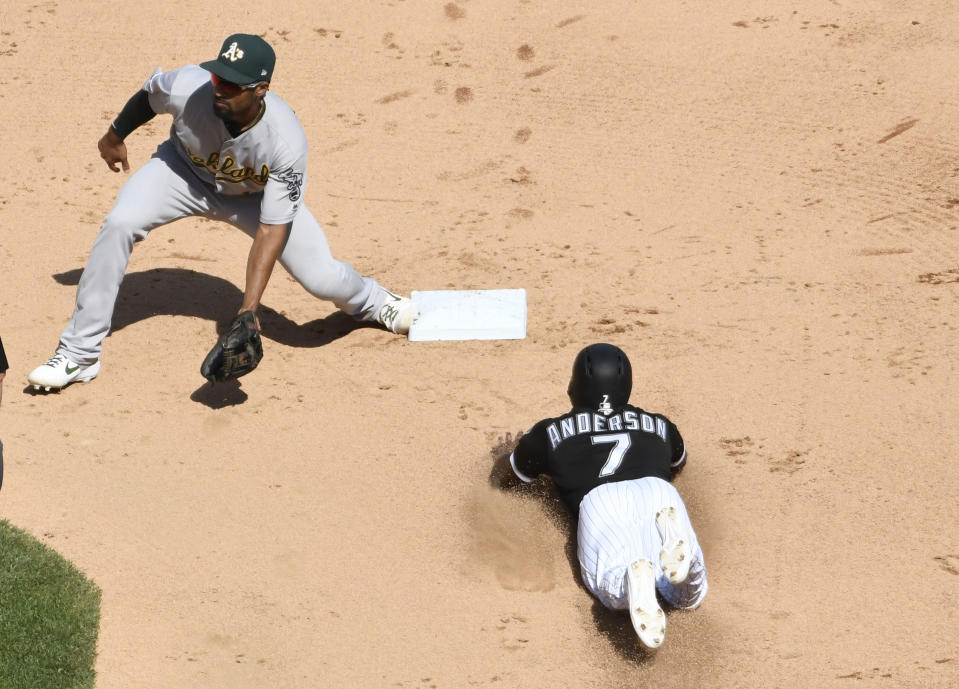 Chicago White Sox's Tim Anderson (7) steals second base as Oakland Athletics shortstop Marcus Semien (10) takes a late throw during the fifth inning of a baseball game, Friday, Aug. 9, 2019, in Chicago. (AP Photo/David Banks)