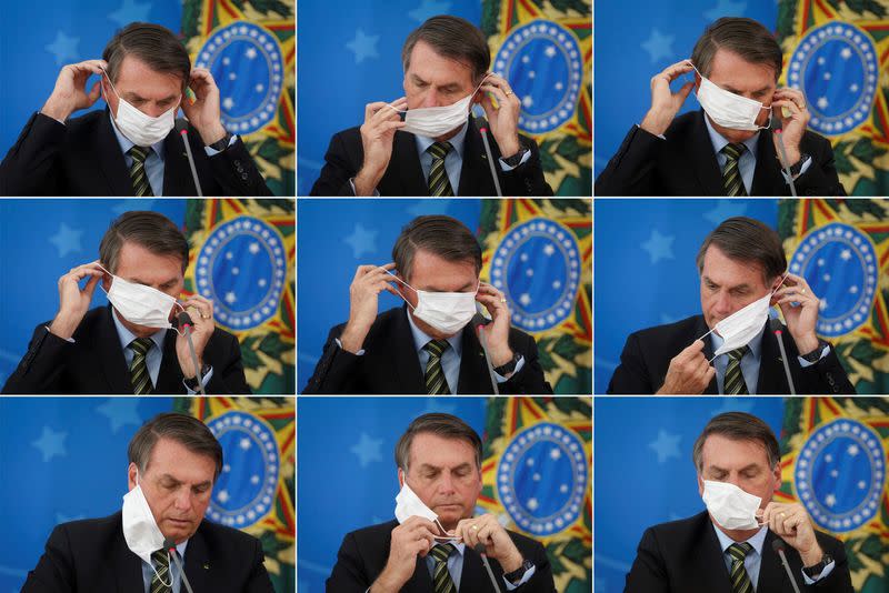 Brazil's President Jair Bolsonaro adjusts his protective face mask during a press statement to announce federal judiciary measures to curb the spread of the coronavirus disease (COVID-19) in Brasilia