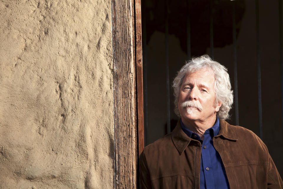 Chris Hillman, a founding member of the Byrds and Flying Burrito Brothers, and one of the architects of country-rock and folk-rock, poses at the Ortega Adobe in Ventura, Calif., on Dec. 3, 2020. Hillman published a memoir, "Time Between: My Life as a Byrd, Burrito Brother and Beyond," revealing what it was like rising to rock 'n' fame in the '60s and the triumphs and tragedy that he witnessed. (Lori Stoll via AP)