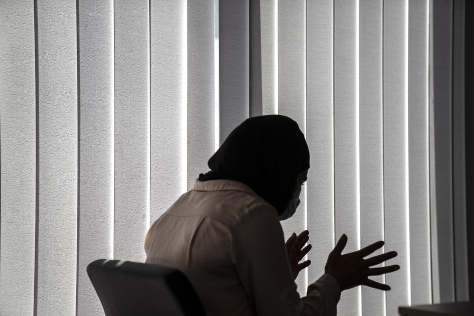 Huda Zaga, a Palestinian woman, speaks during an interview with The Associated Press, in Samos island, Greece, Wednesday, June 9, 2021. The woman and her three children apparently eluded Greek authorities after reaching Samos in April with nearly three dozen other migrants, who were returned to Turkey. The Zuga family applied for and were granted asylum, adding credence to allegations that summary deportations, known as pushbacks, are occurring, despite Greece’s denials. (AP Photo/Petros Giannakouris)