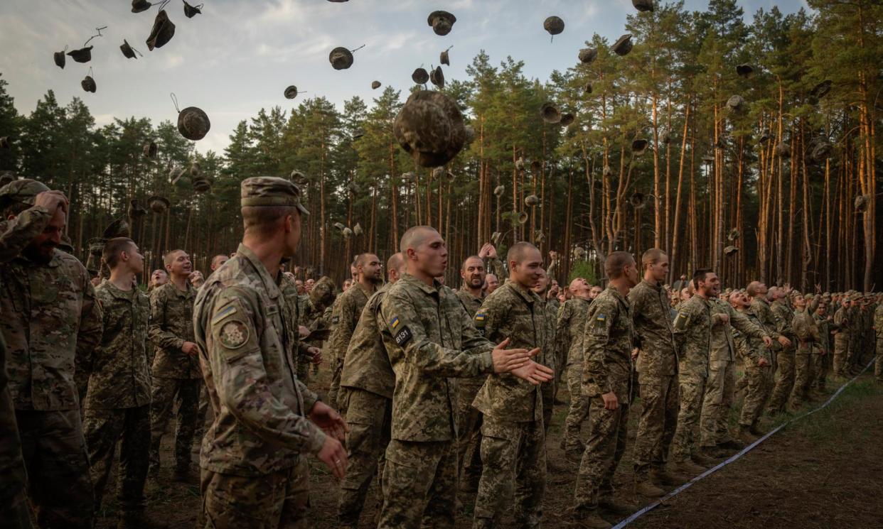 <span>Newly recruited soldiers celebrating the end of their training at a military base close to Kyiv.</span><span>Photograph: Efrem Lukatsky/AP</span>