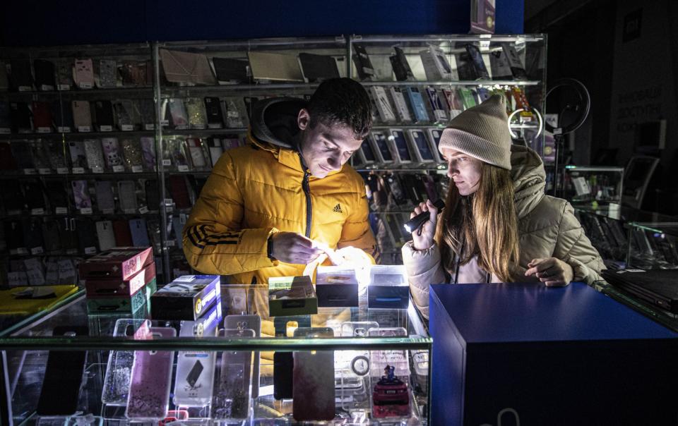 People charge batteries of their mobile phones at "Points of Invincibility", special shelters established for all basic services across the country after power cuts - Anadolu Agency