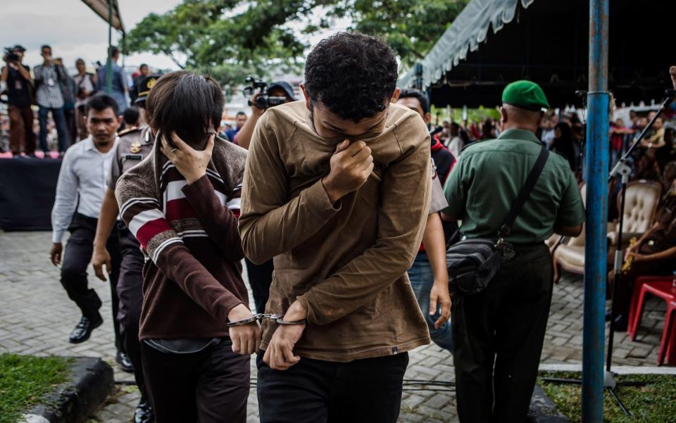 The two young gay men, aged 20 and 23, were caned 85 times each in the Indonesian province of Aceh during a public ceremony - Credit: GETTY