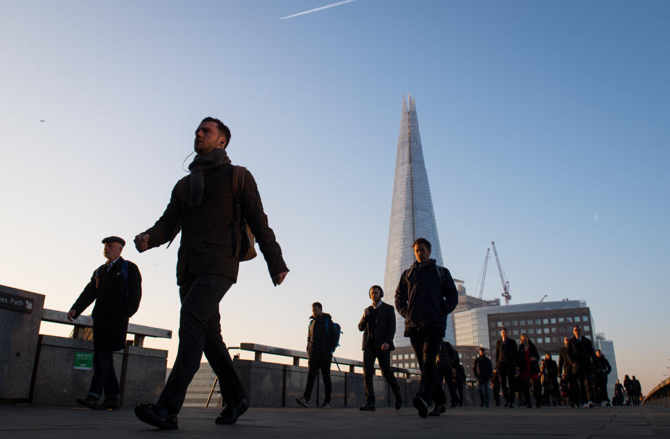 Commuters cross London Bridge, in central London, as Britain could experience more record-breaking temperatures this week. (Photo by Dominic Lipinski/PA Images via Getty Images)