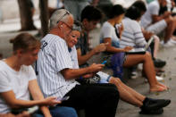 People use the internet at a hotspot in Havana, Cuba, December 18, 2018. REUTERS/Stringer