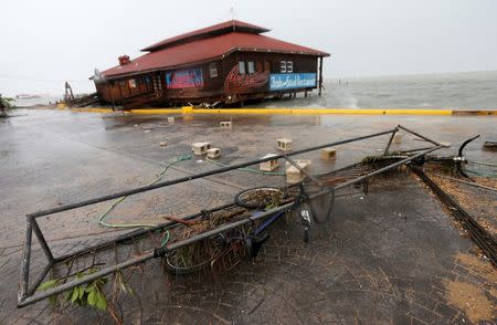 A bicycle and debris are seen along the beach, after Hurricane Earl hits, in Belize City, Belize August 4, 2016. REUTERS/Henry Romero