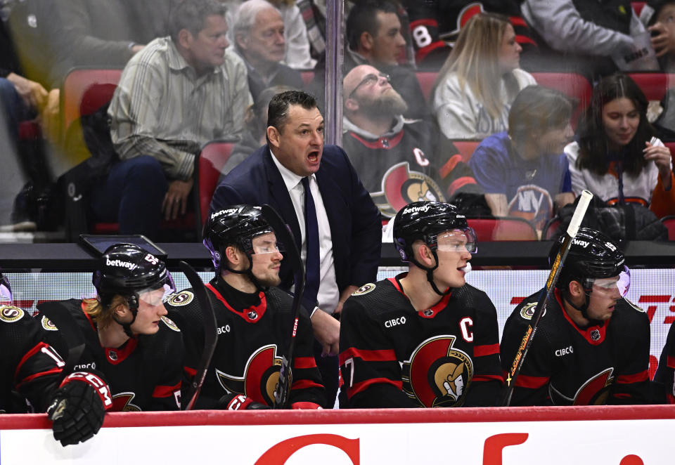 Ottawa Senators head coach D.J. Smith, center, stands behind the bench during first-period NHL hockey game action against the New York Islanders in Ottawa, Ontario, Friday, Nov. 24, 2023. (Justin Tang/The Canadian Press via AP)