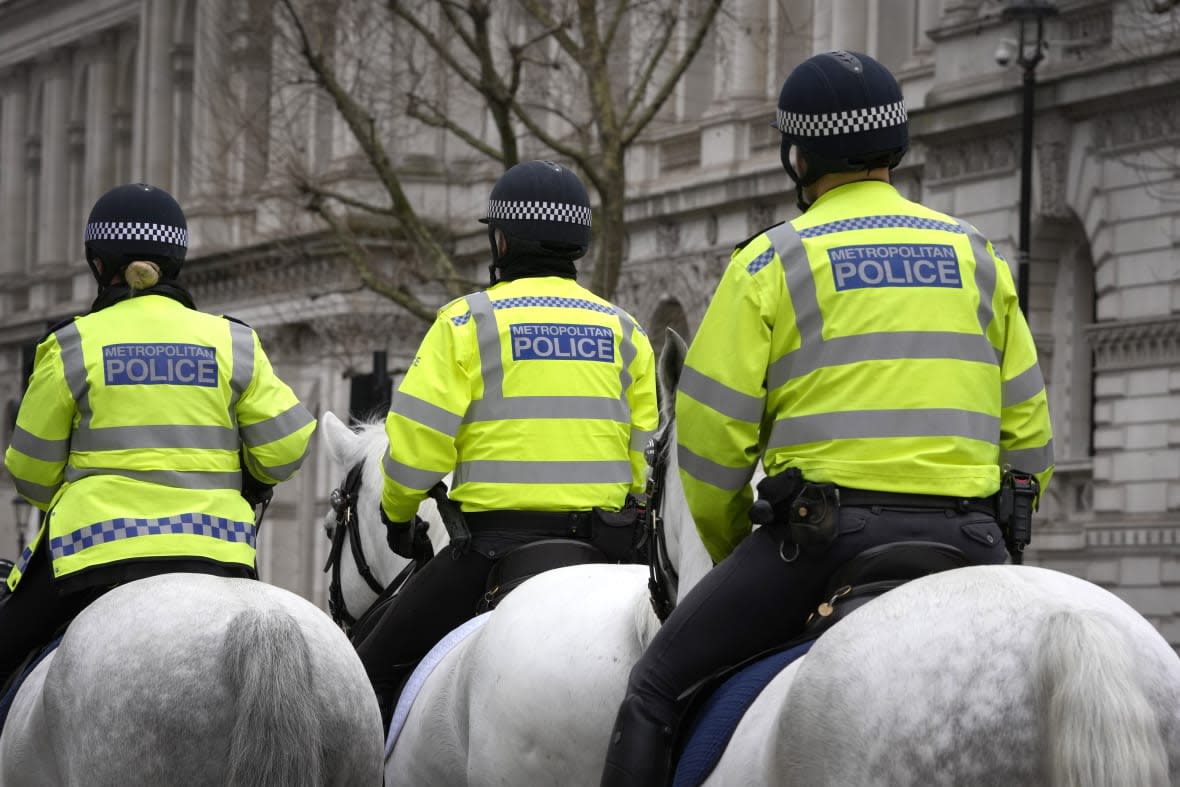 Police officers ride in Westminster in London, Tuesday, March 21, 2023. (AP Photo/Kirsty Wigglesworth)