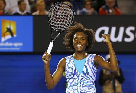 Venus Williams of the U.S. celebrates defeating Agnieszka Radwanska of Poland in their women's singles fourth round match at the Australian Open 2015 tennis tournament in Melbourne January 26, 2015. REUTERS/Issei Kato