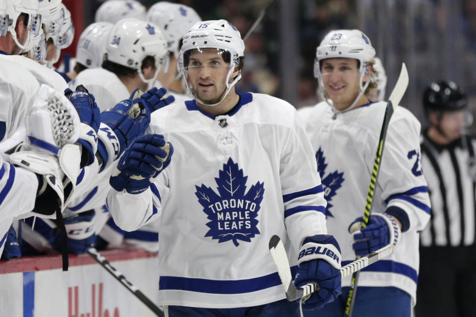 Toronto Maple Leafs center Alexander Kerfoot (15) is congratulated by teammates after scoring a goal against the Minnesota Wild in the first period of an NHL hockey game Tuesday, Dec. 31, 2019, in St. Paul, Minn. (AP Photo/Andy Clayton-King)