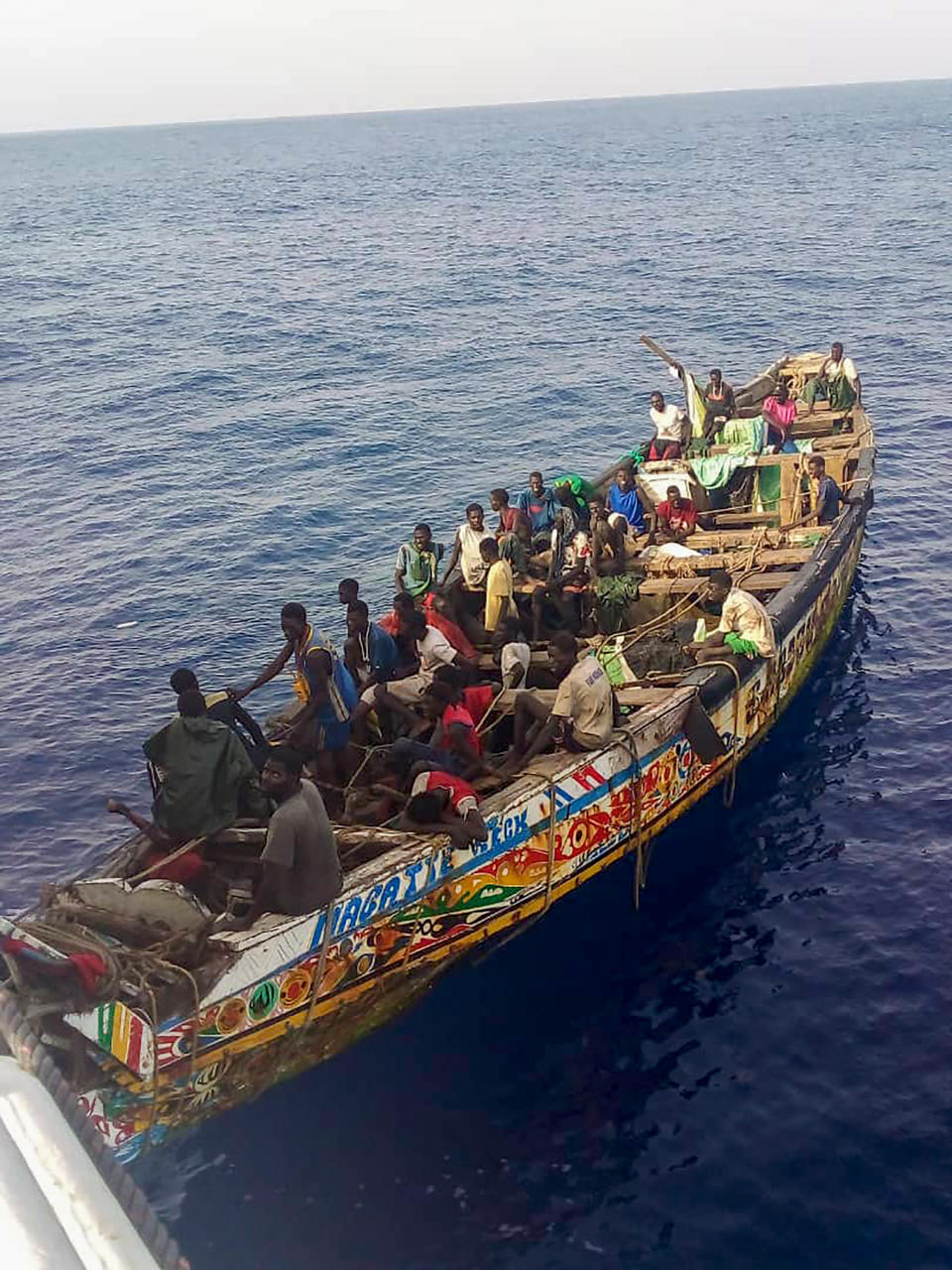 Survivors, mostly from Senegal, are seen inside a pirogue that was found adrift in the Atlantic Ocean by a Spanish fishing vessel near Cape Verde on August 14, 2023. The boat had set off from Senegal on July 10 to try to reach Spain's Canary Islands with more than 100 people on board, officials said, but only 38 people survived and more than 60 are feared dead. (AP Photo)