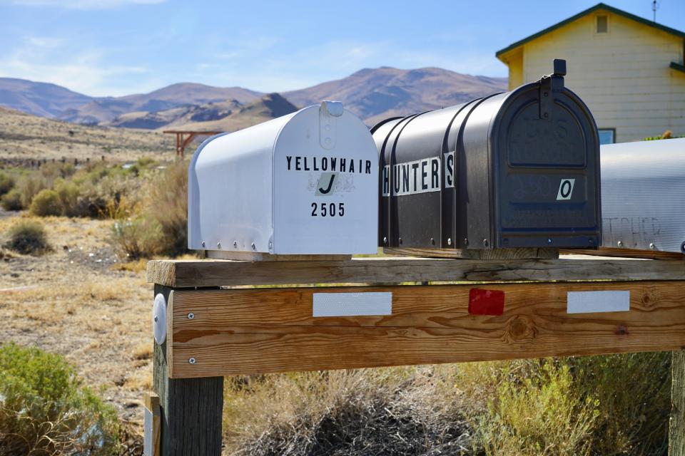 A small group of boxes, which the U.S. Postal Service delivers mail to, sits outside of Sutcliffe, Nev., on the Pyramid Lake Paiute Reservation on Tuesday, Sept. 8, 2020. All other members of the Pyramid Lake Paiute Tribe living elsewhere on the reservation get their mail at a post office in Nixon, Nev. which is 30 miles (48 kilometers) away. Throughout the reservation, residents plan to take advantage of a recent law change that will allow them to collect and return ballots on behalf of others amid the coronavirus pandemic. (AP Photo/Sam Metz)