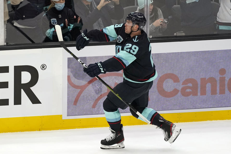 Seattle Kraken's Vince Dunn reacts after scoring against the Vancouver Canucks during the first period of an NHL hockey game Saturday, Oct. 23, 2021, in Seattle. (AP Photo/Elaine Thompson)