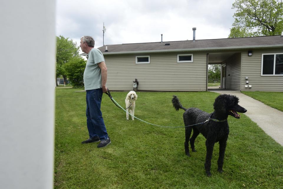 Dale Newell, of Sequim, Washington., walks his two dogs at the Port Huron Township RV Park on Water Street Thursday, May 26, 2022. He and his wife, who's from Port Huron, arrived in their camper Tuesday. The township park has been a regular stop for the couple for six years.