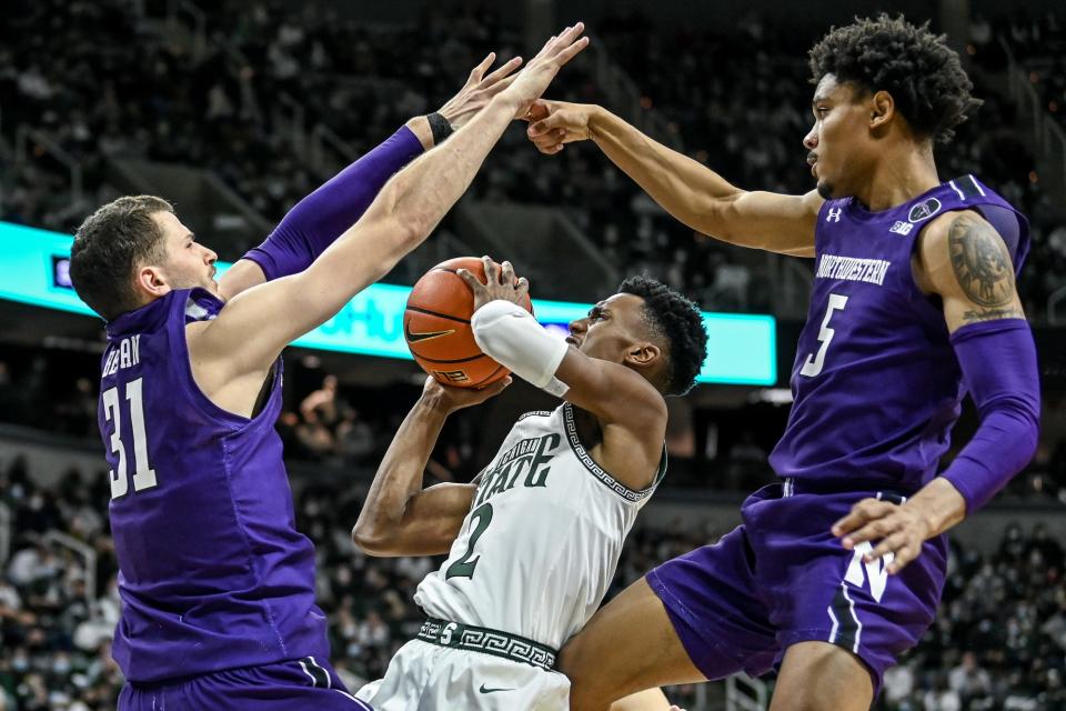 Michigan State's Tyson Walker, center, shoots as Northwestern's Robbie Beran, left, and Julian Roper II, right, defend during the second half on Saturday, Jan. 15, 2022, at the Breslin Center in East Lansing.