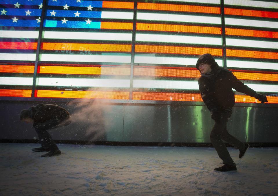 People have a snowball fight in Times Square in New York