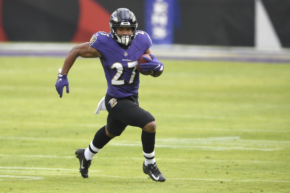 Baltimore Ravens running back J.K. Dobbins runs with the ball against the Jacksonville Jaguars during the first half of an NFL football game, Sunday, Dec. 20, 2020, in Baltimore. (AP Photo/Nick Wass)