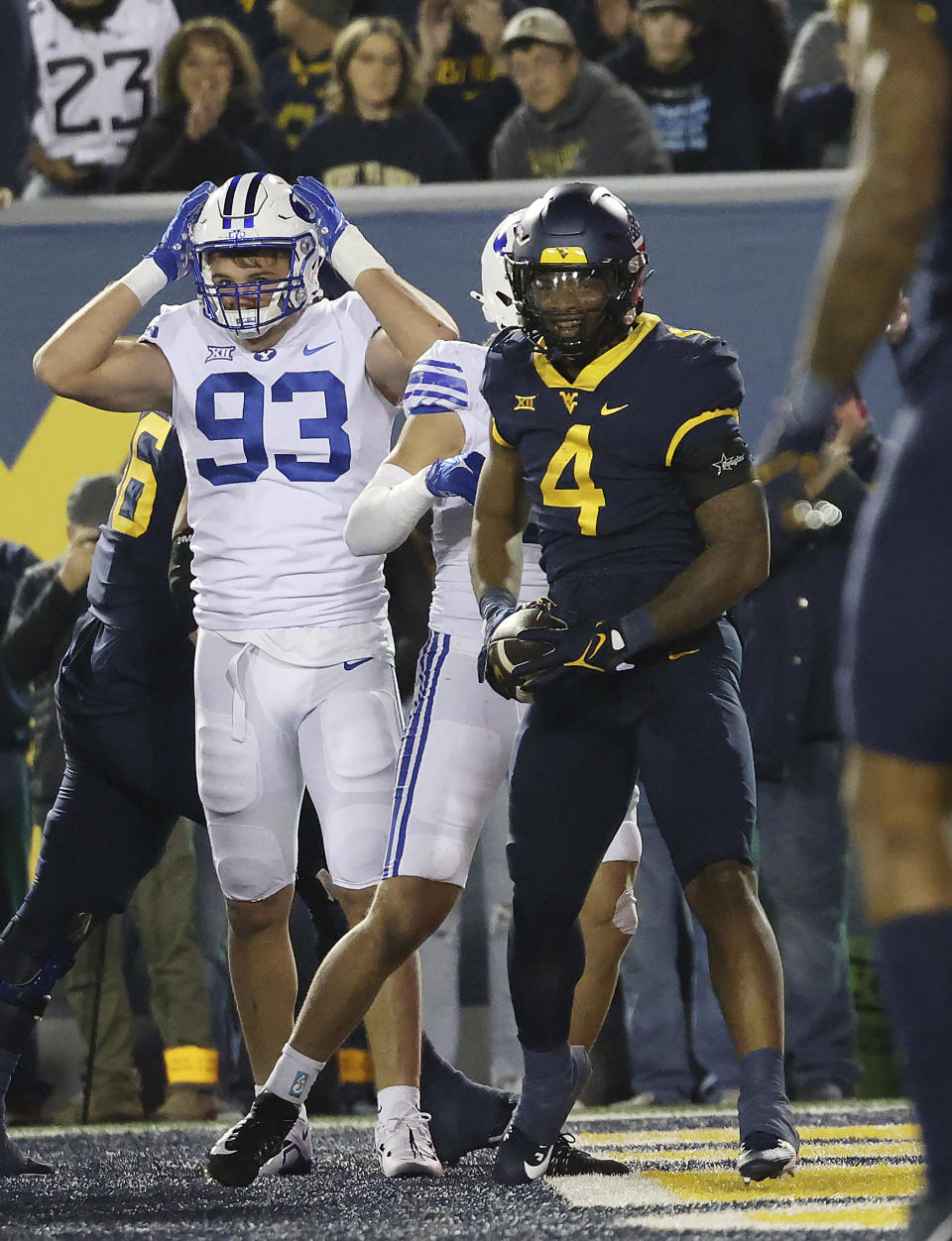 West Virginia running back C.J. Donaldson (4) celebrates after scoring a rushing touchdown during the first half of an NCAA college football game against BYU on Saturday, Nov. 4, 2023, in Morgantown, W.Va. West Virginia won 37-7. (AP Photo/Chris Jackson)