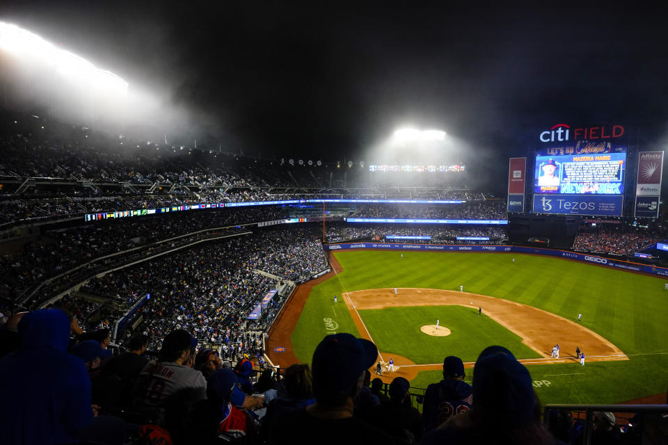 Fans watch the second inning of a baseball game between the New York Mets and the Seattle Mariners, Saturday, May 14, 2022, in New York. (AP Photo/Frank Franklin II)