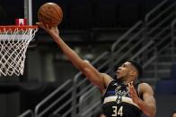 Milwaukee Bucks forward Giannis Antetokounmpo (34) puts in a layup during the first half of an NBA basketball game against the Toronto Raptors Wednesday, Jan. 27, 2021, in Tampa, Fla. (AP Photo/Chris O'Meara)