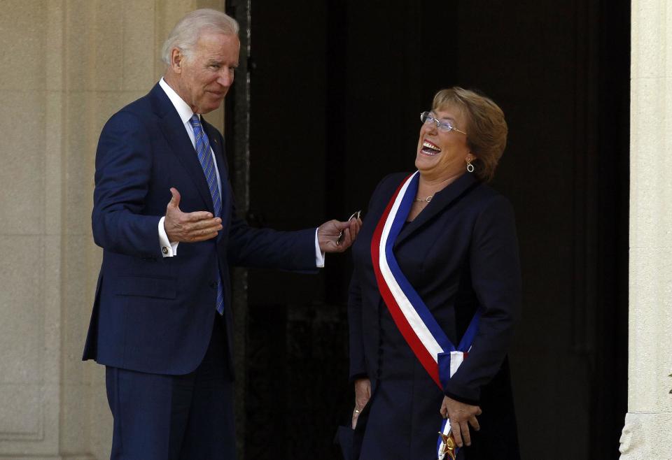 Chile's newly sworn-in President Michelle Bachelet receives Vice President Joe Biden on the front steps of the Cerro Castillo presidential residence, in Vina del Mar, Chile on Tuesday, March 11, 2014. Bachelet, who led Chile from 2006-2010, was sworn-in as president on Tuesday. (AP Photo/Luis Hidalgo).