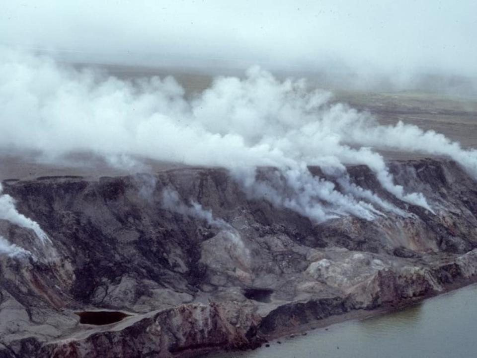 The sea cliffs of Franklin Bay with active burning shale send clouds of smoke inland. (Submitted by Natural Resources Canada - image credit)