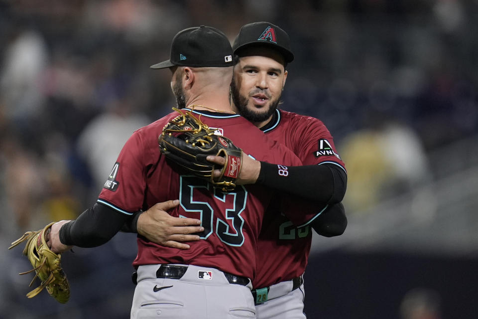 Arizona Diamondbacks third baseman Eugenio Suarez, right, celebrates with teammate first baseman Christian Walker after the Diamondbacks defeated the San Diego Padres 4-3 in a baseball game Thursday, June 6, 2024, in San Diego. (AP Photo/Gregory Bull)