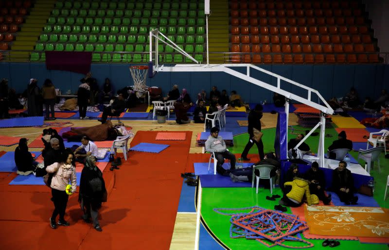 People rest at a temporary shelter camp in a basketball arena, after an earthquake in Elazig