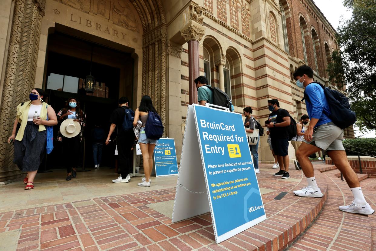 Students are seen at the entrance of the Library on campus of the University of California, Los Angeles UCLA, in Los Angeles. (Credit: Xinhua via Getty Images)