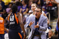 Connecticut Sun's head coach Curt Miller, right, greets his players during a timeout in the second half of Game 3 of a WNBA basketball playoff game against the Los Angeles Sparks, Sunday, Sept. 22, 2019, in Long Beach, Calf. (AP Photo/Ringo H.W. Chiu)