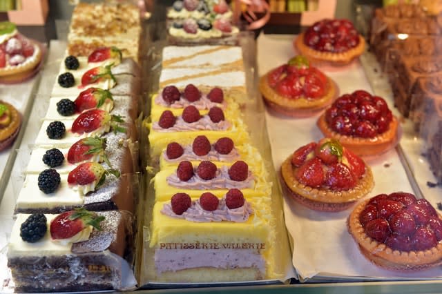 Patisserie Valerie cakes on display in a shop window