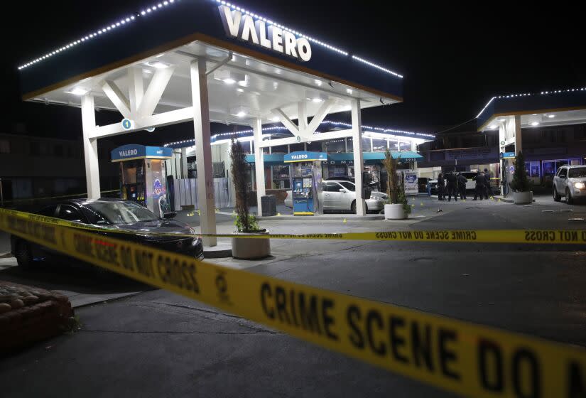 Oakland police investigate a multiple shooting and homicide at the Valero gas station on Seminary Avenue at MacArthur Boulevard in Oakland, Calif., on Monday, Jan. 23, 2023. (Jane Tyska/Bay Area News Group via AP)