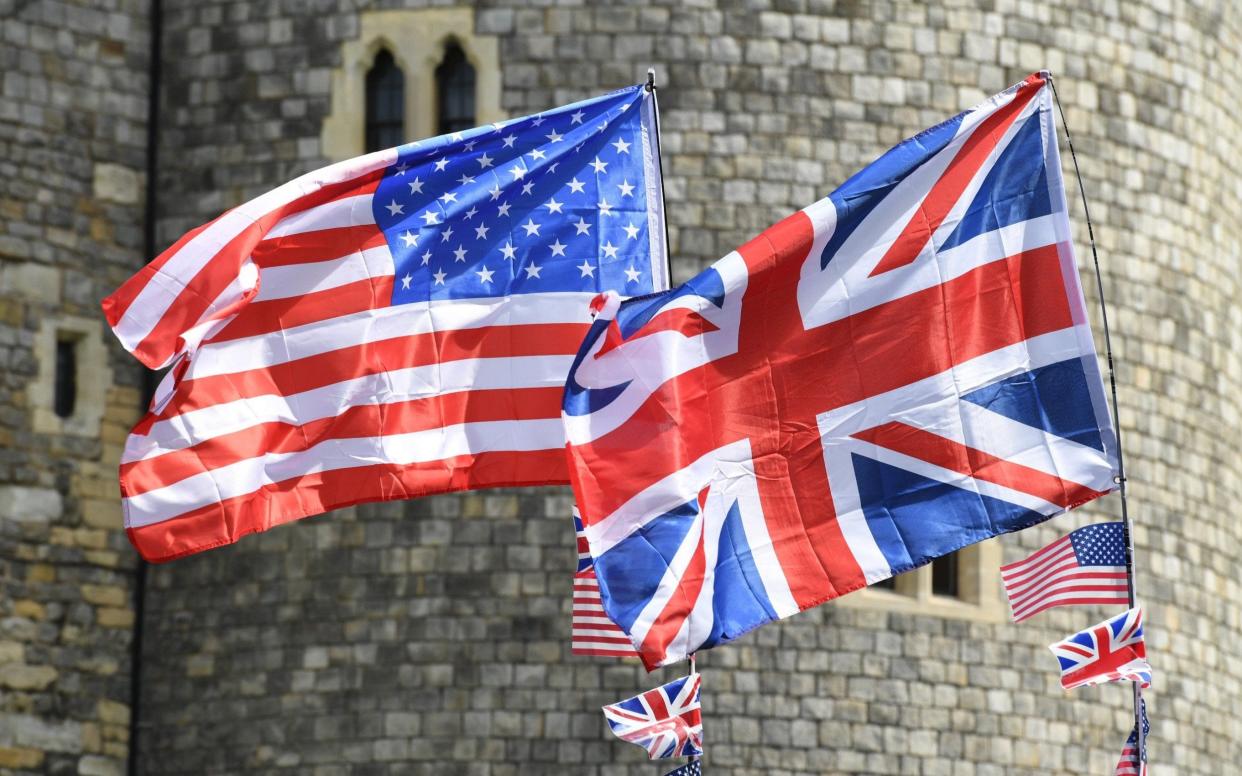 A Union Jack flag of the United Kingdom and the Stars and Stripes of the United States fly against the castle - Getty Images Europe