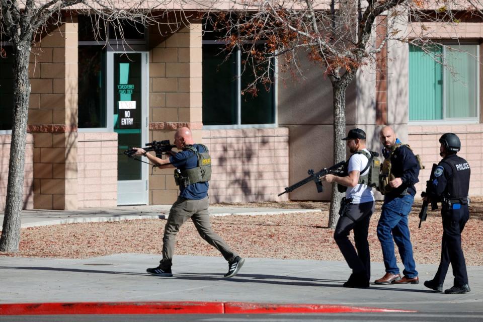 Law enforcement officers head into the University of Nevada, Las Vegas, campus after reports of an active shooter (AP)