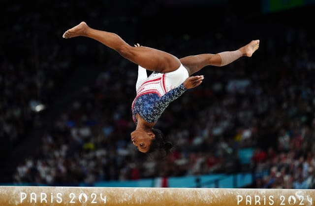 Simone Biles performing on the balance beam