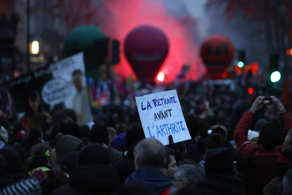 Protestors march during a demonstration against pension changes, Thursday, Jan. 19, 2023 in Paris. Workers in many French cities took to the streets Thursday to reject proposed pension changes that would push back the retirement age, amid a day of nationwide strikes and protests seen as a major test for Emmanuel Macron and his presidency. (AP Photo/Lewis Joly)