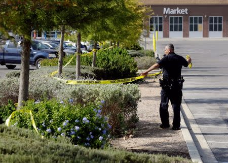 A police officer works on a crime scene after eight people believed to be illegal immigrants being smuggled into the United States were found dead inside a sweltering 18-wheeler trailer parked behind a Walmart store in San Antonio, Texas, U.S. July 23, 2017. REUTERS/Ray Whitehouse